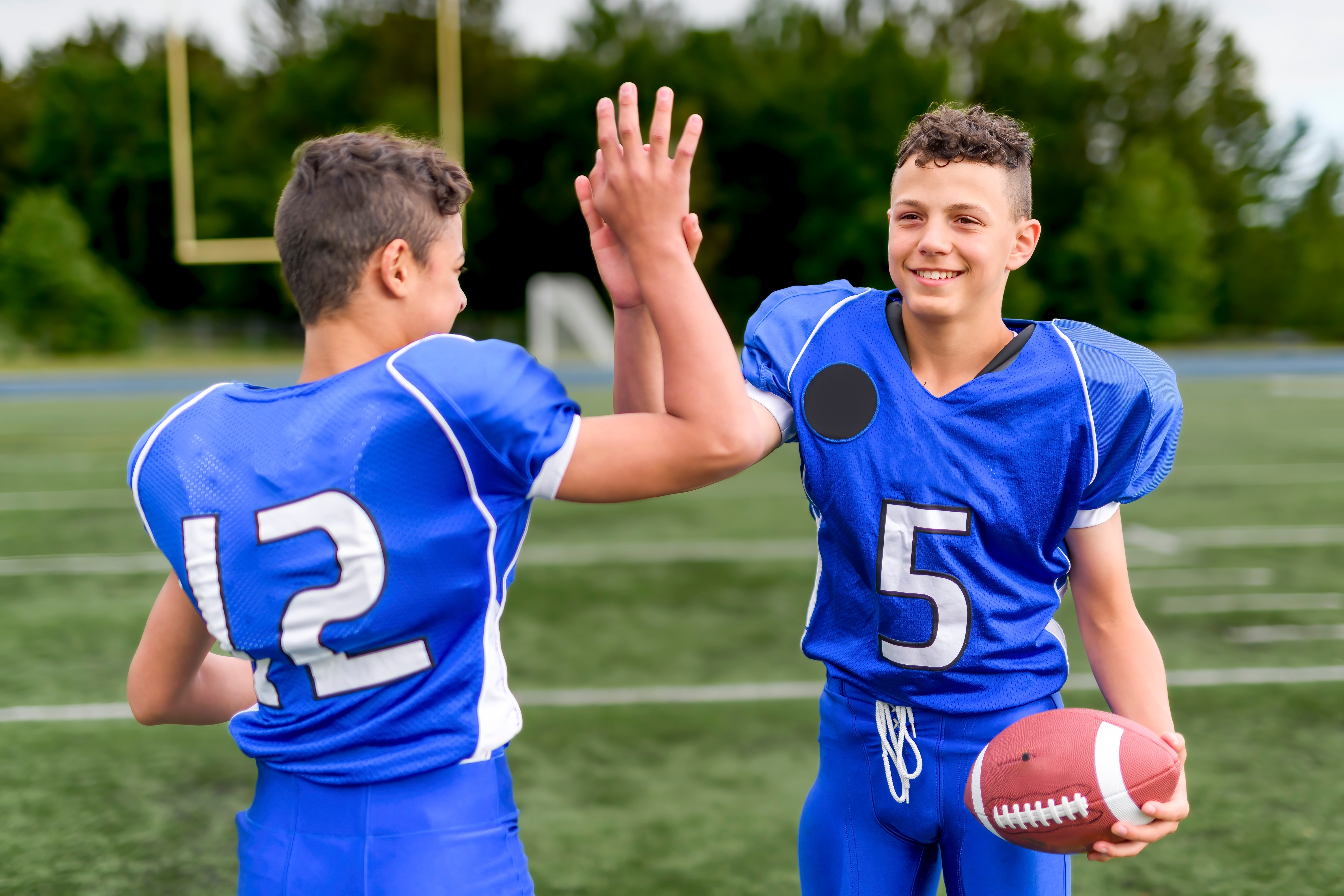 Youth football players celebrating — Mighty Shine Car Wash fundraising in Ladson, SC